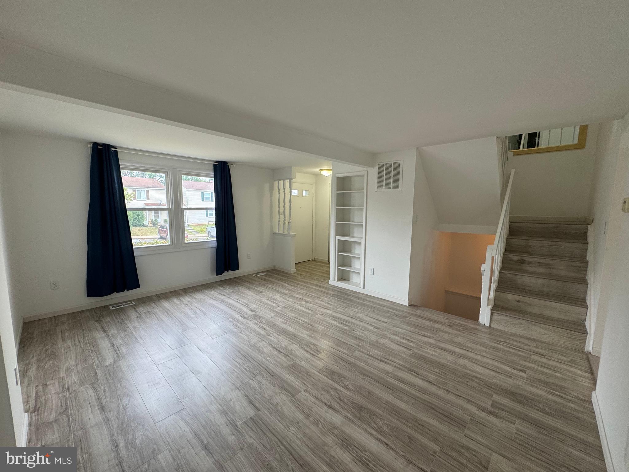1757 Carriage Way Frederick, MD 21702 - Photo 12 of 42 wooden floor in an empty room with a window