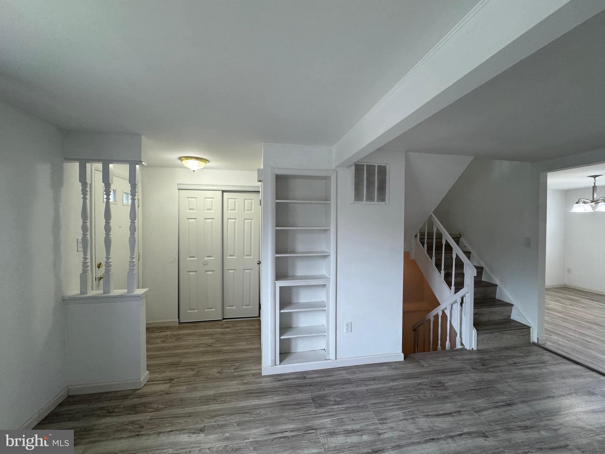 1757 Carriage Way Frederick, MD 21702 - Photo 13 of 42 a view of an empty room with wooden floor and stairs