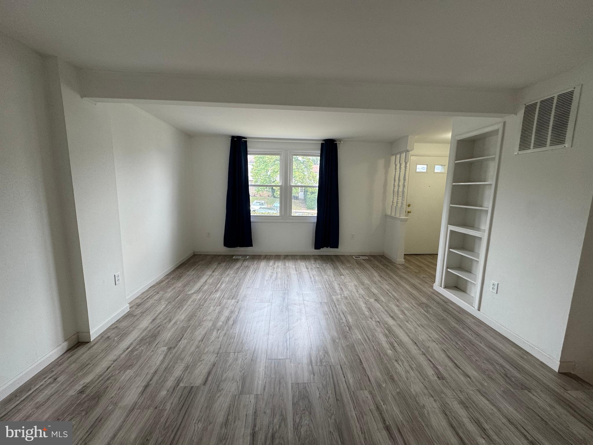 1757 Carriage Way Frederick, MD 21702 - Photo 15 of 42 wooden floor in an empty room with a window