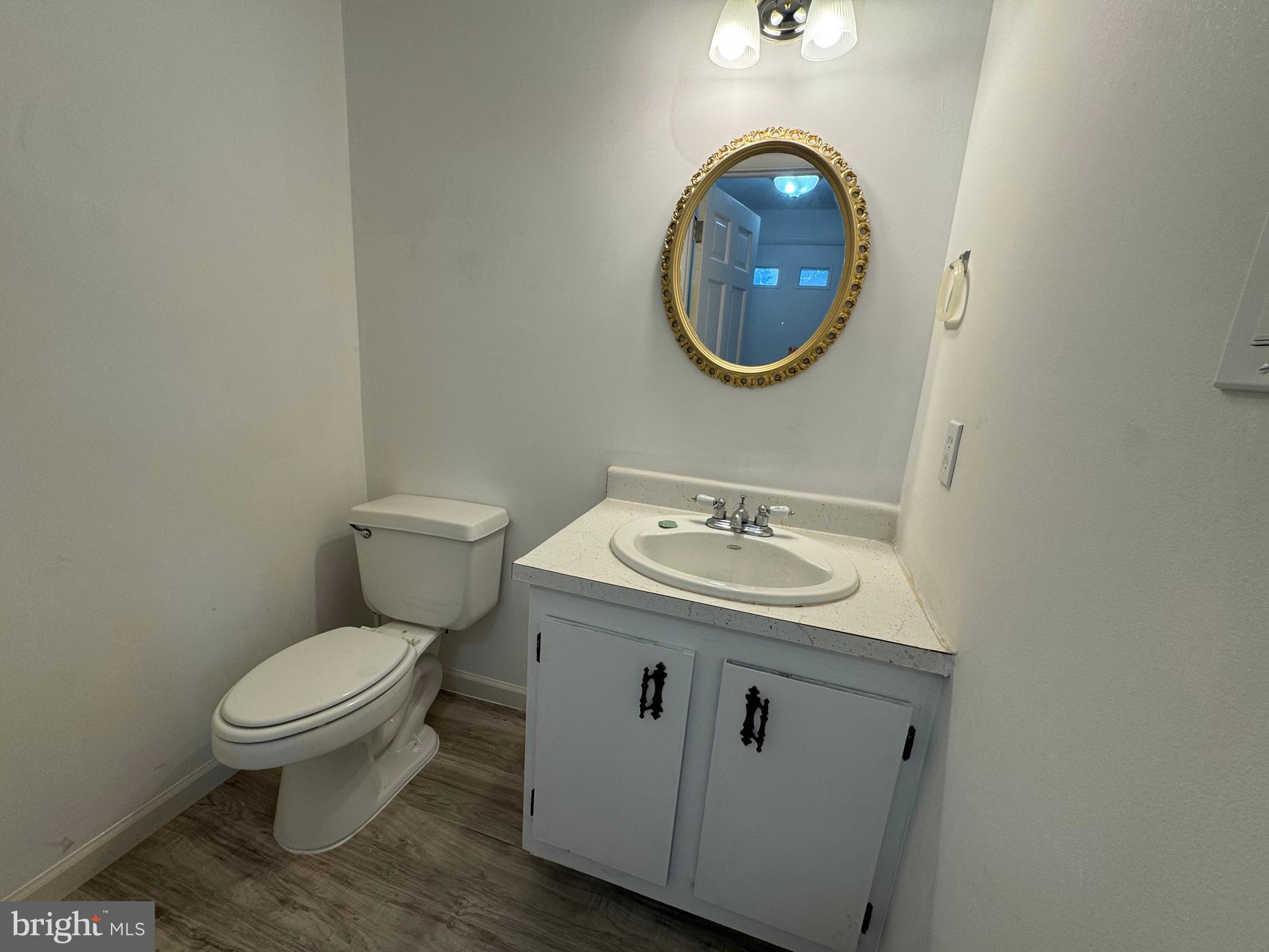 1757 Carriage Way Frederick, MD 21702 - Photo 17 of 42 a bathroom with a toilet a sink and a mirror