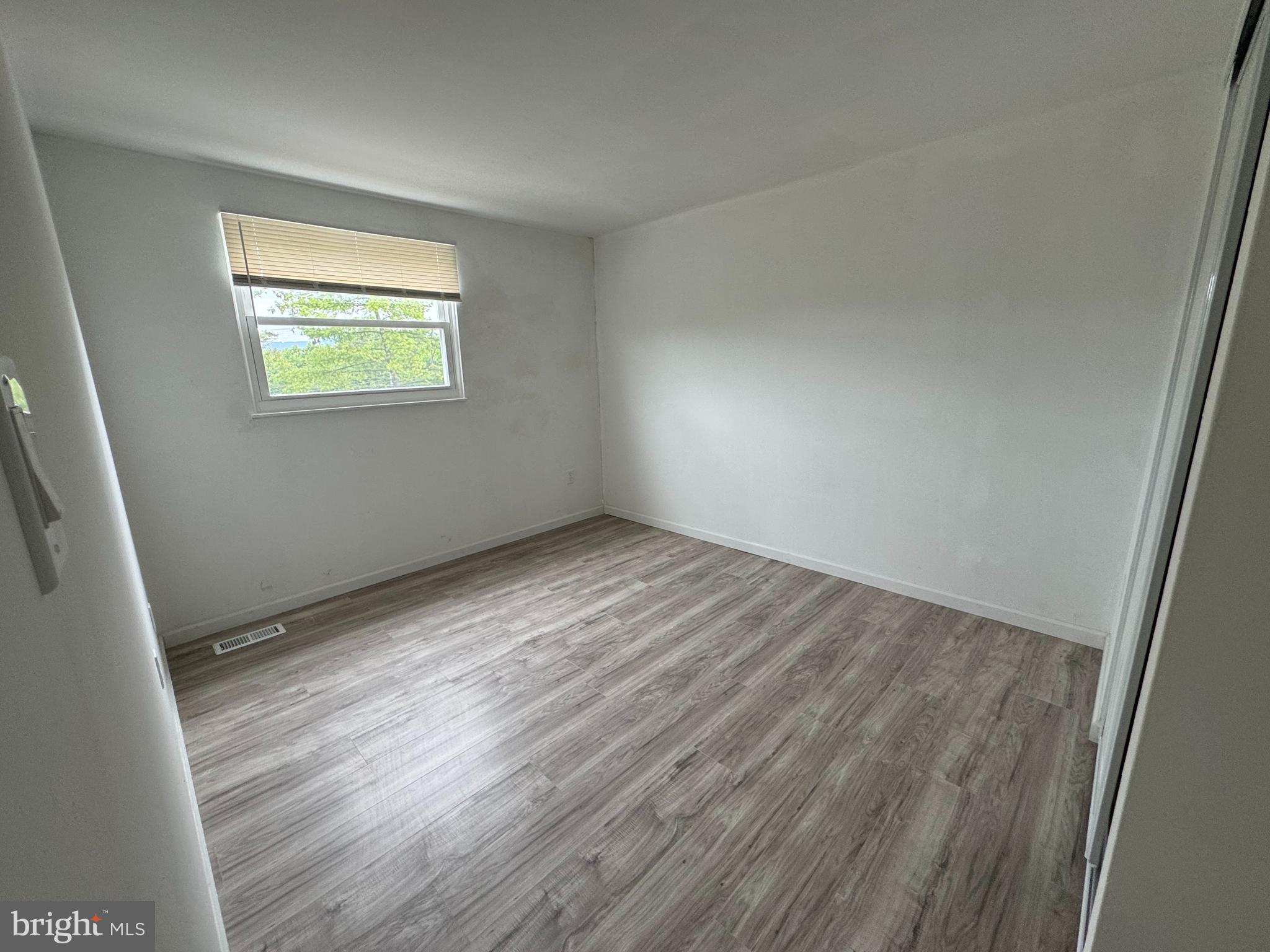 1757 Carriage Way Frederick, MD 21702 - Photo 26 of 42 a view of an empty room with wooden floor and a window