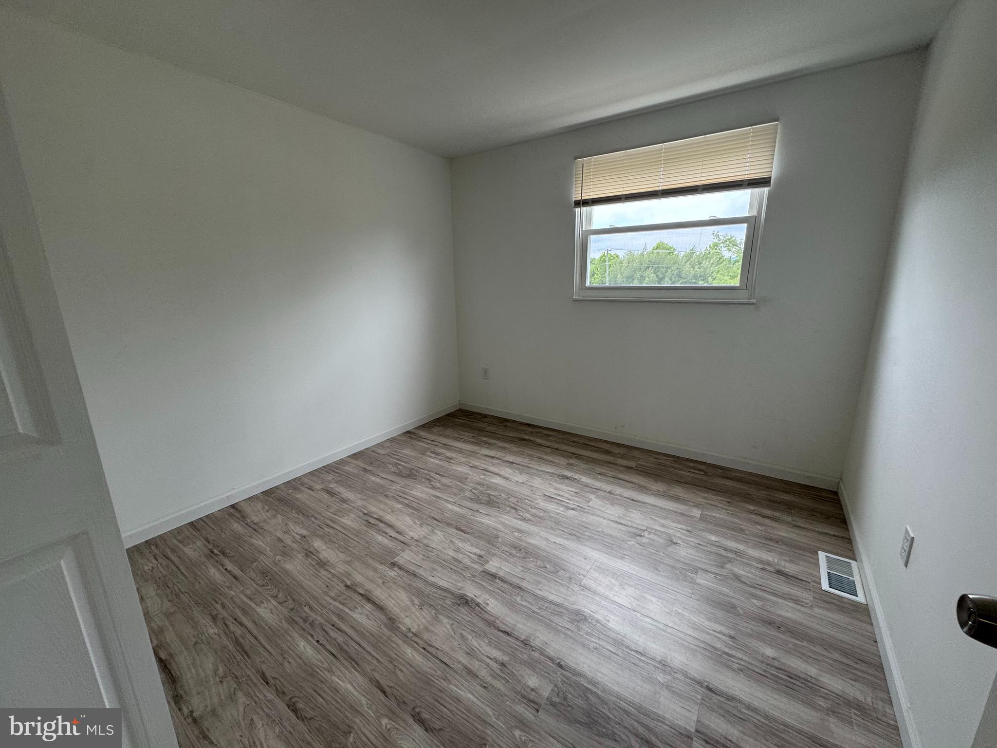 1757 Carriage Way Frederick, MD 21702 - Photo 28 of 42 a view of an empty room with wooden floor and a window