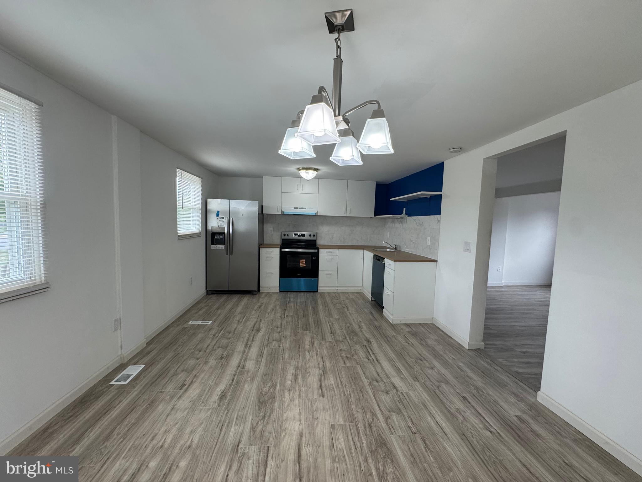 1757 Carriage Way Frederick, MD 21702 - Photo 3 of 42 a view of a kitchen with stainless steel appliances granite countertop a hardwood floor sink and stove