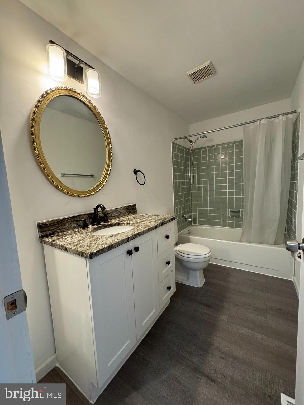 1757 Carriage Way Frederick, MD 21702 - Photo 32 of 42 a bathroom with a granite countertop toilet a sink and a mirror
