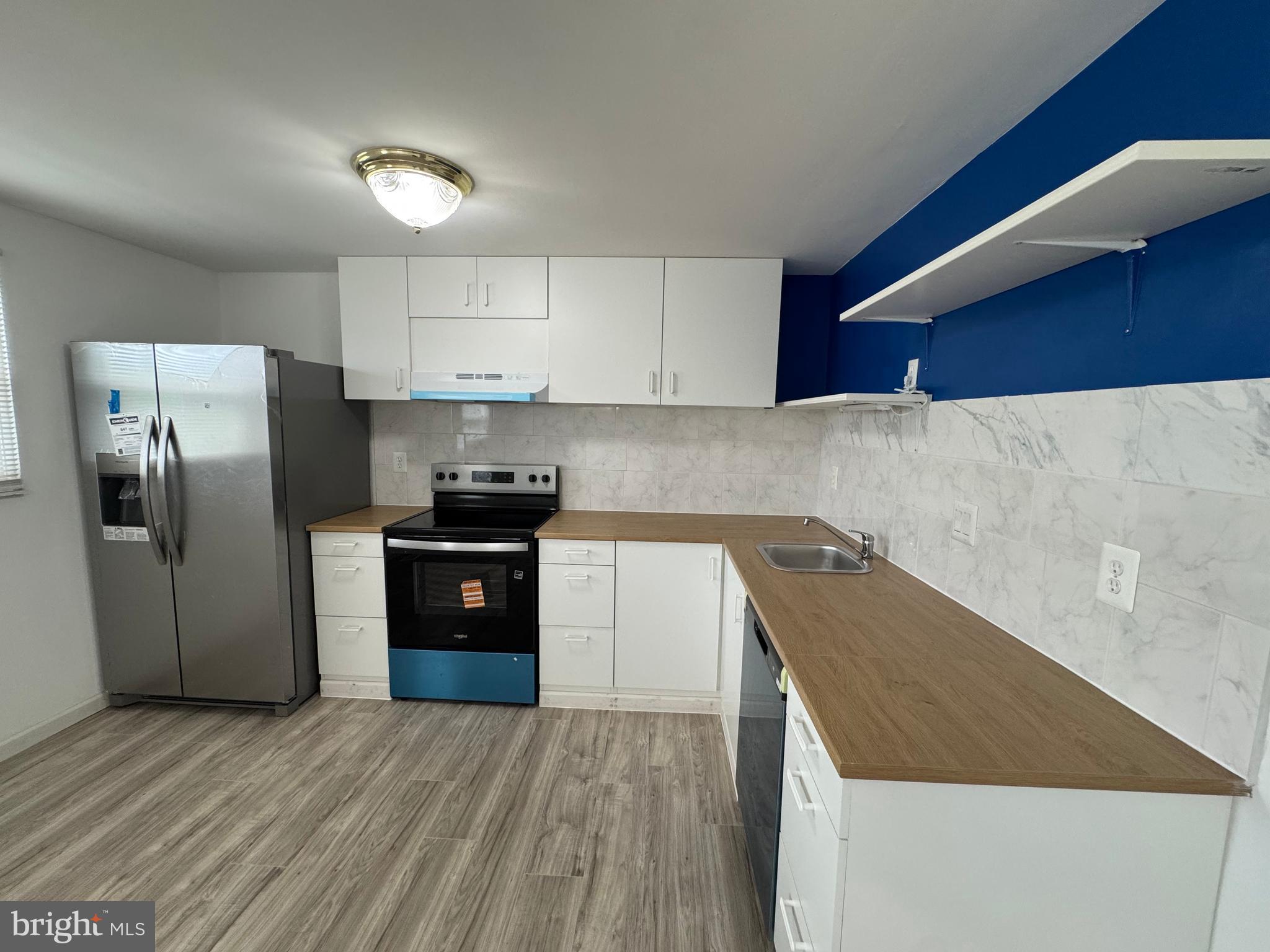 1757 Carriage Way Frederick, MD 21702 - Photo 5 of 42 a kitchen with a refrigerator and a sink