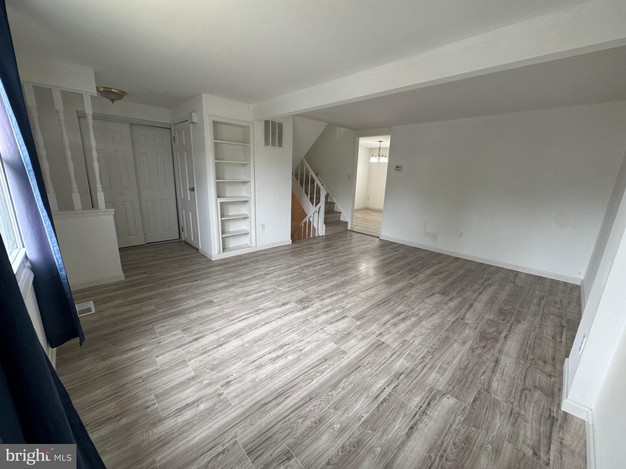 1757 Carriage Way Frederick, MD 21702 - Photo 9 of 42 wooden floor in an empty room with a window
