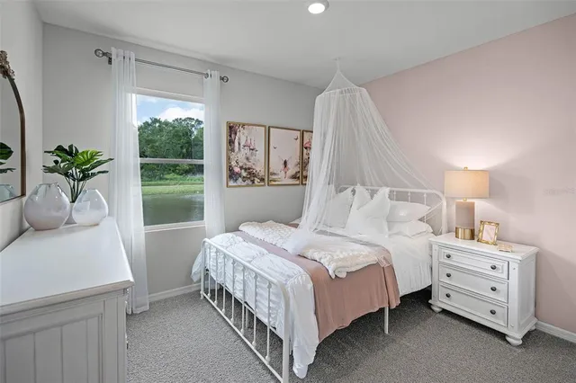 a bedroom with a bed and a potted plant