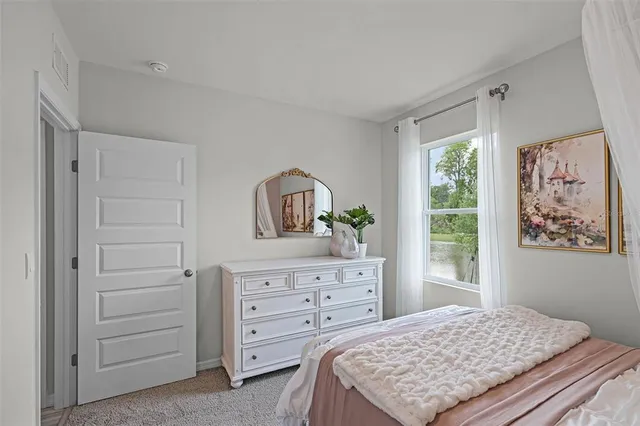 a bedroom with a bed and a dresser