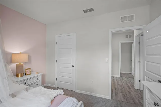 a room with a bed and a tv on the dresser