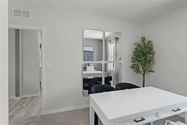 a living room with furniture and potted plant