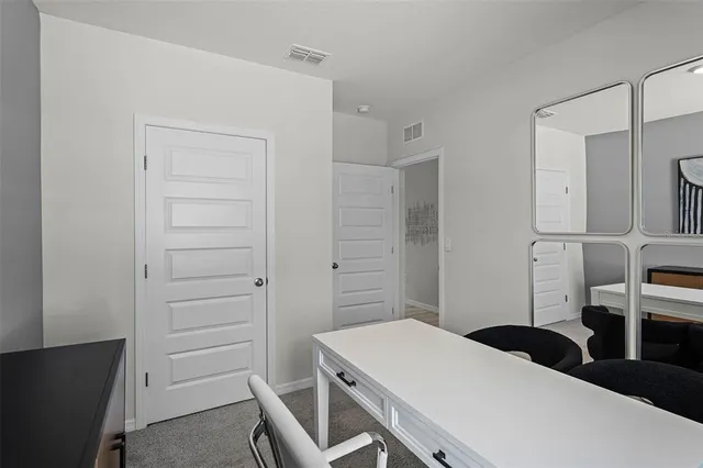 a bedroom with a bed and cabinets