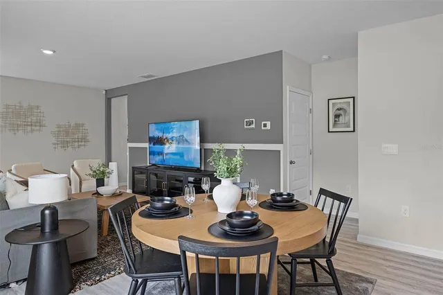 a dining room with furniture and wooden floor