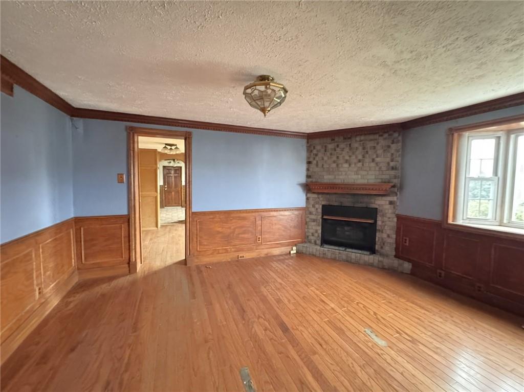 1913 Fox Way Pittsburgh, PA 15203 - Photo 5 of 9 a view of empty room with wooden floor and fireplace