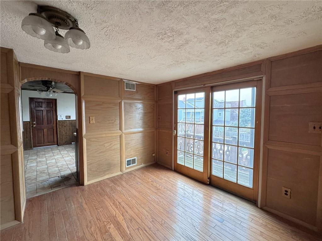 1913 Fox Way Pittsburgh, PA 15203 - Photo 6 of 9 a view of an empty room with window and wooden floor