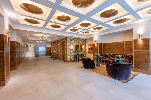 a lobby with furniture and a rug