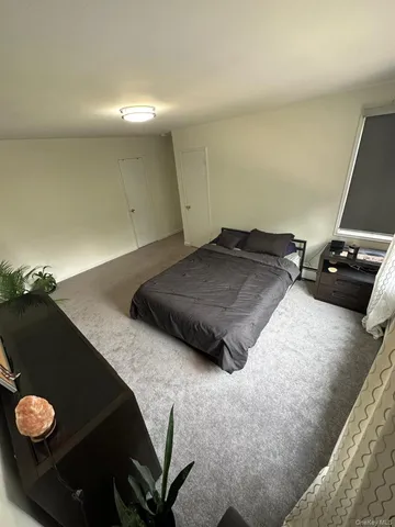 a bedroom with a bed and a chair