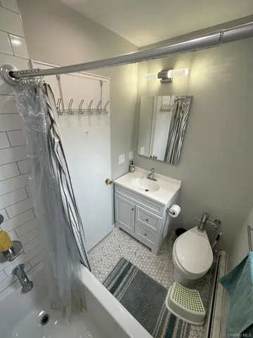 a bathroom with a sink mirror vanity and toilet