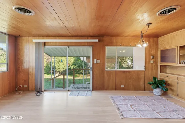 a view of a room with furniture and a window