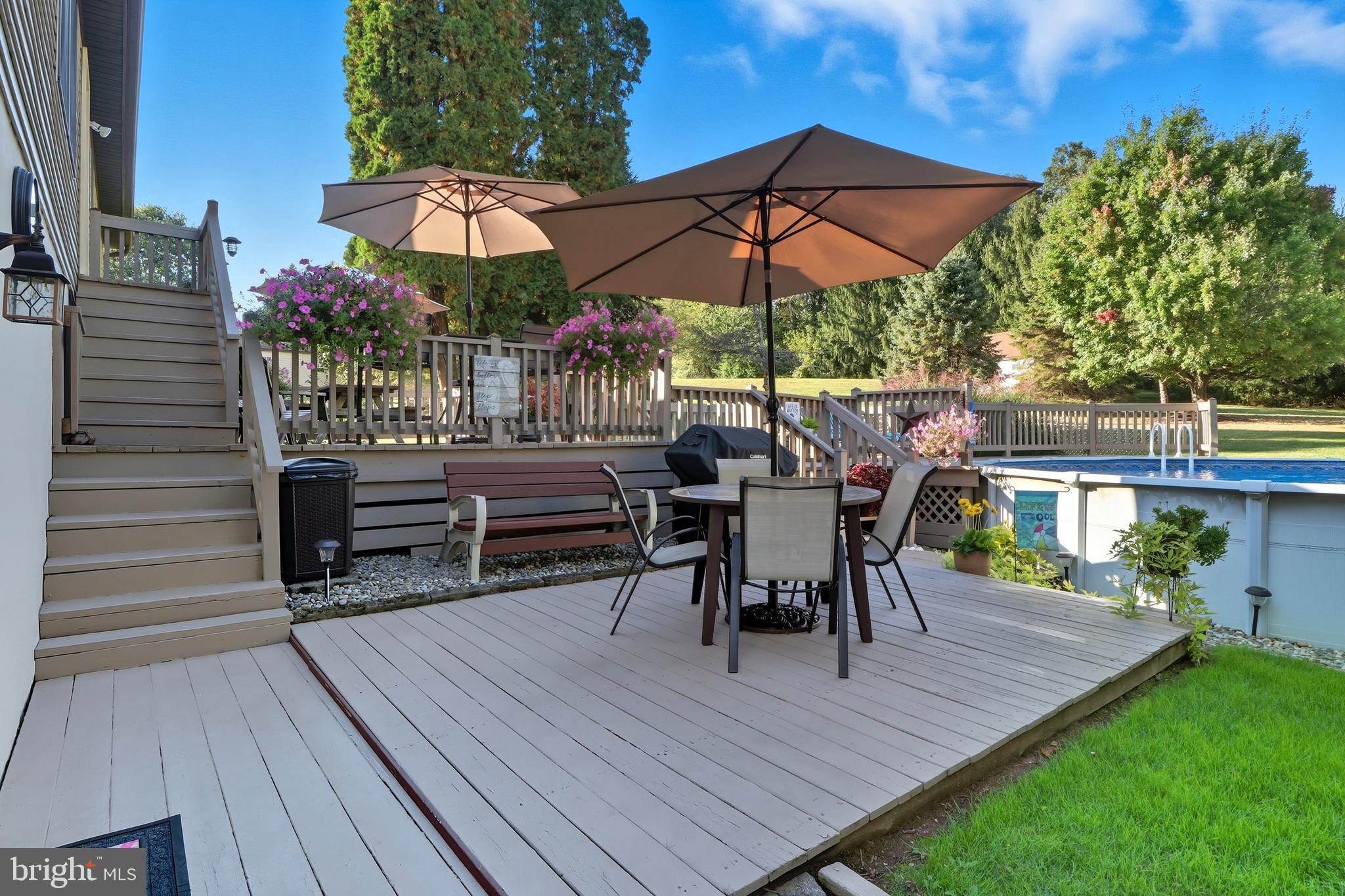 935 Pleasant Grove Road Red Lion, PA 17356 - Photo 35 of 70 a view of a roof deck with table and chairs under an umbrella with wooden floor