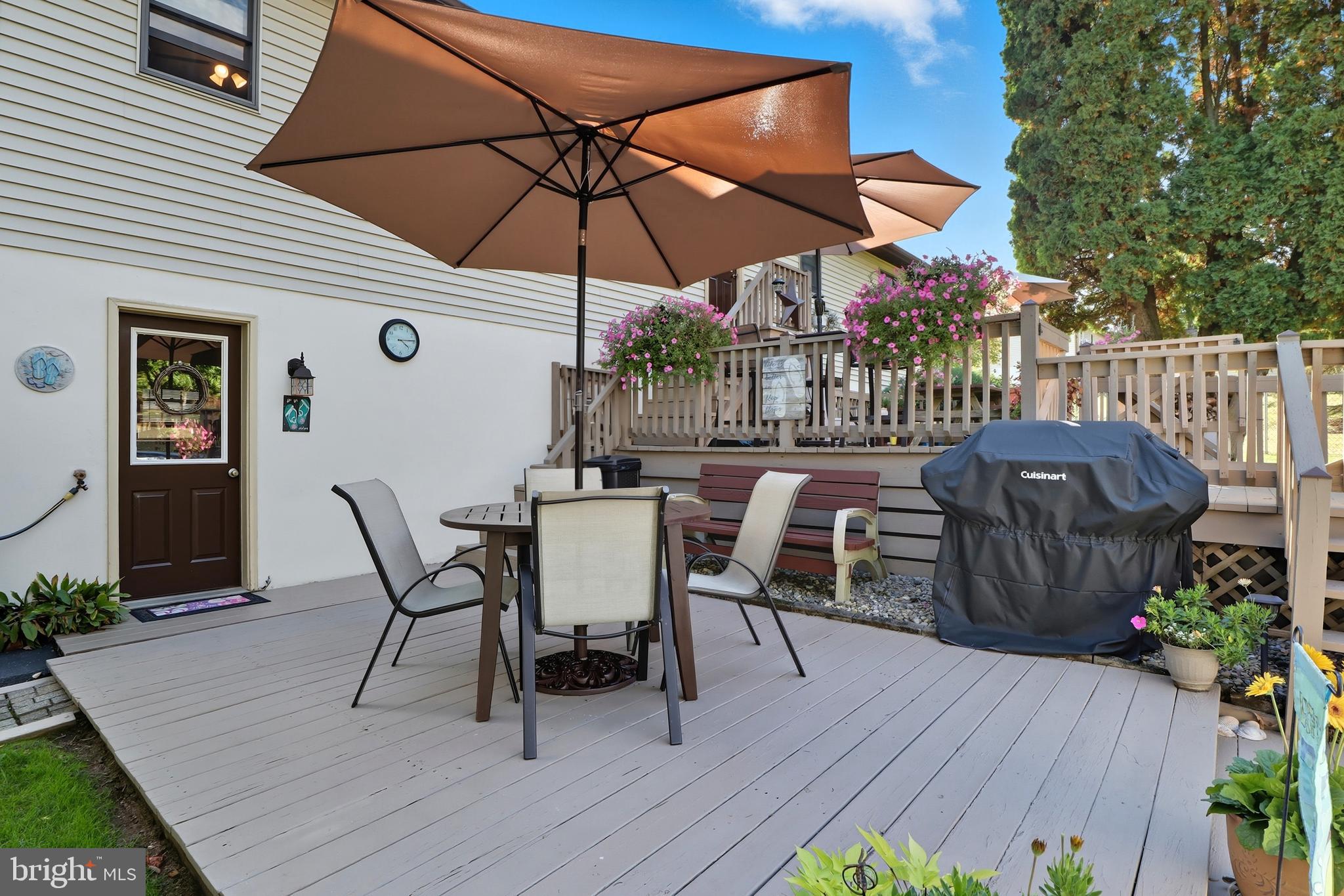 935 Pleasant Grove Road Red Lion, PA 17356 - Photo 36 of 70 a view of a roof deck with table and chairs under an umbrella