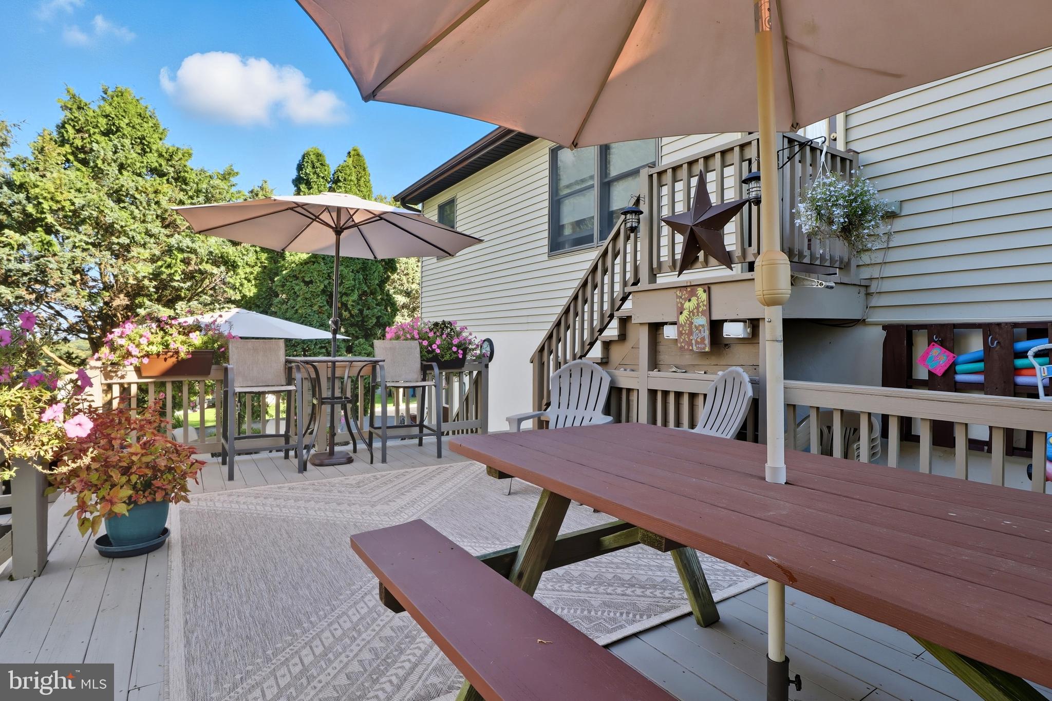 935 Pleasant Grove Road Red Lion, PA 17356 - Photo 38 of 70 a view of a patio with a table and chairs under an umbrella