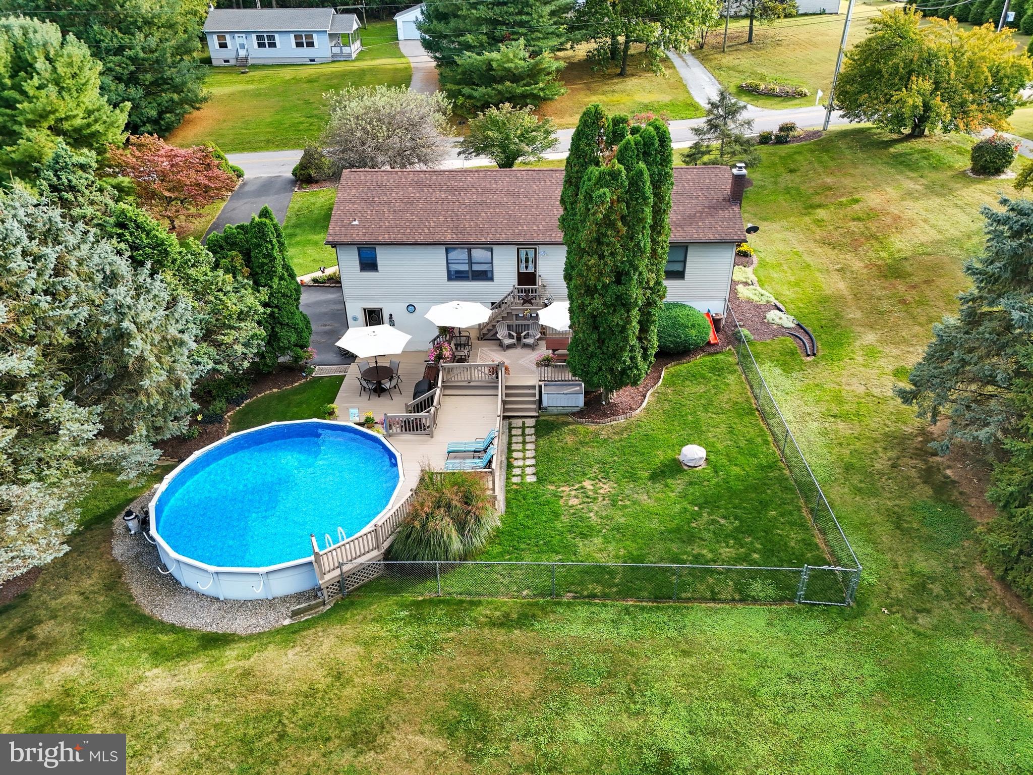 935 Pleasant Grove Road Red Lion, PA 17356 - Photo 61 of 70 a view of a backyard with table and chairs under an umbrella