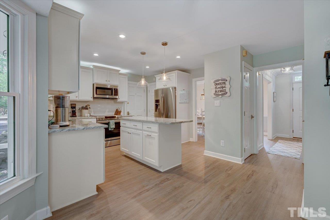 22 Swallows Ridge Court Durham, NC 27713 - Photo 11 of 33 a open kitchen with white cabinets and stainless steel appliances