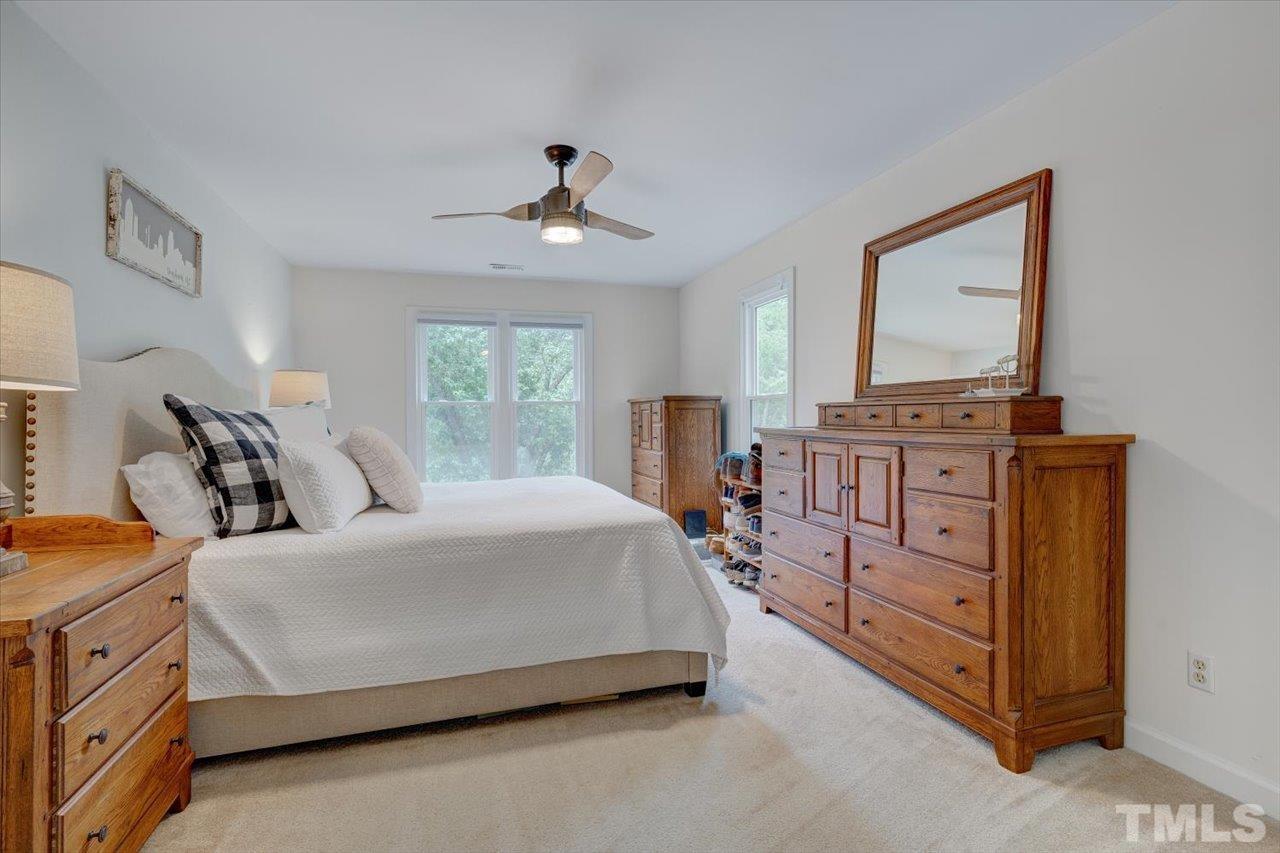 22 Swallows Ridge Court Durham, NC 27713 - Photo 22 of 33 a bedroom with a bed a dresser and next to a window
