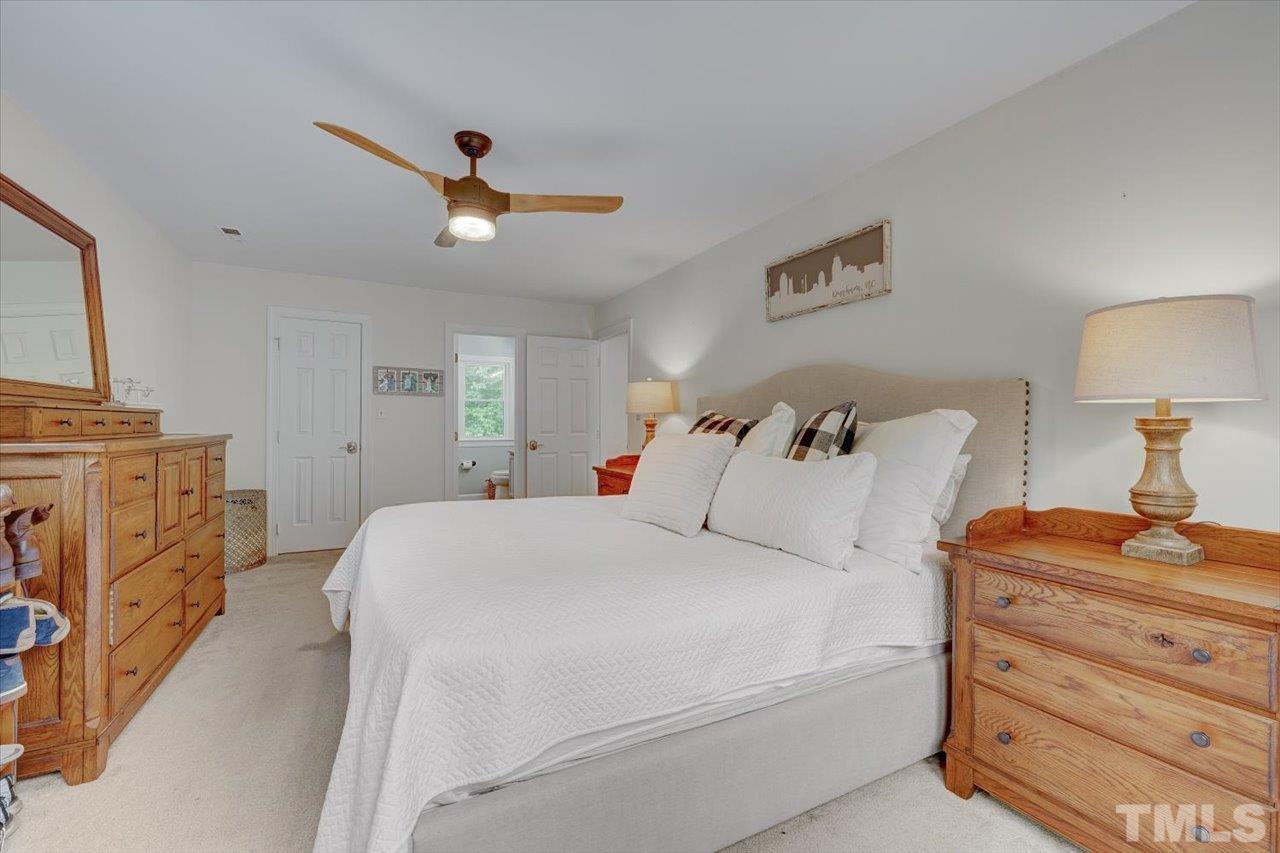 22 Swallows Ridge Court Durham, NC 27713 - Photo 23 of 33 a bed room with a bed and a lamp