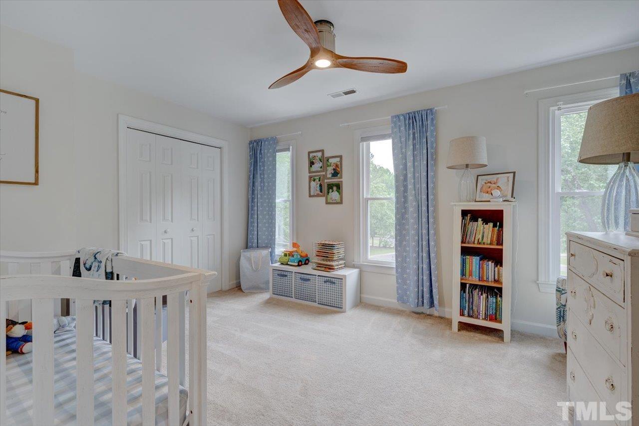 22 Swallows Ridge Court Durham, NC 27713 - Photo 26 of 33 a bedroom with furniture and a book shelf