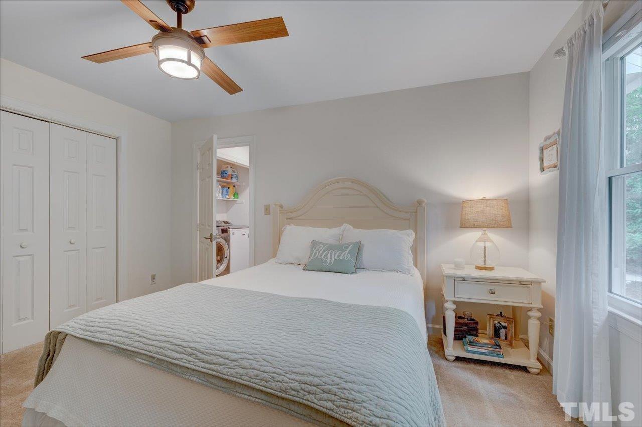 22 Swallows Ridge Court Durham, NC 27713 - Photo 30 of 33 a bedroom with a bed and a chandelier