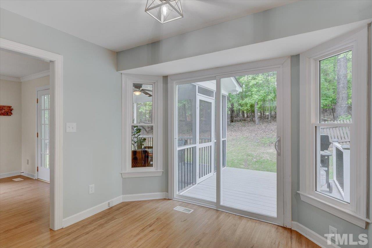 22 Swallows Ridge Court Durham, NC 27713 - Photo 10 of 33 an empty room with wooden floor and windows