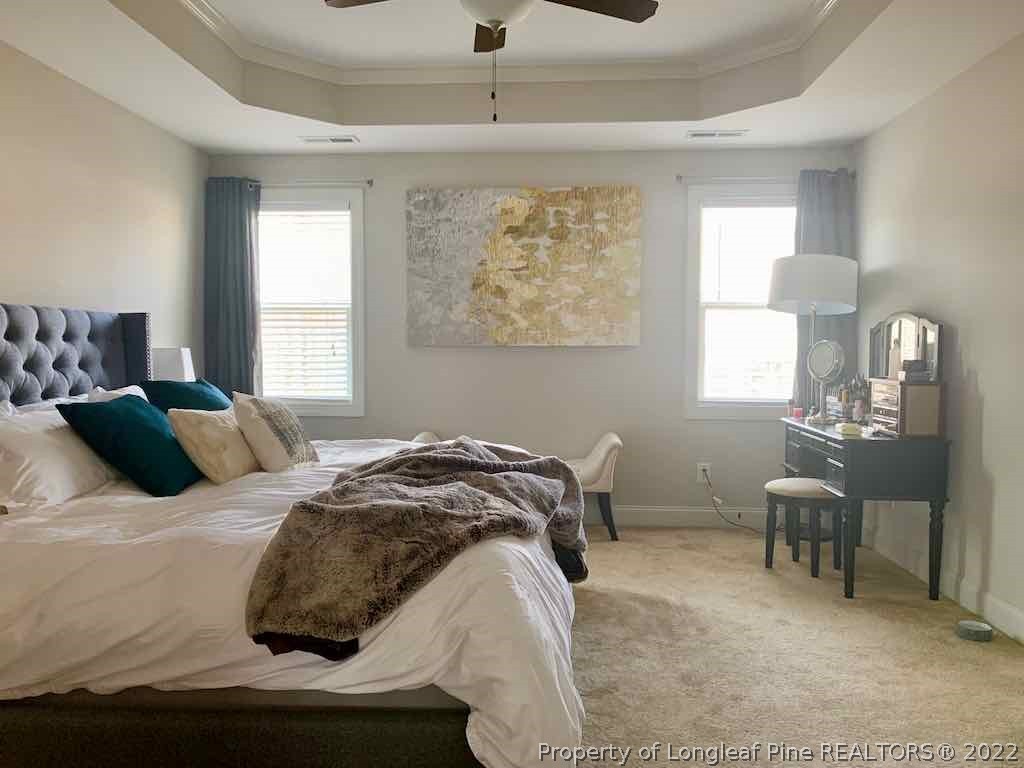 60 Wildlife Bridge Court Spring Lake, NC 28390 - Photo 4 of 5 a bedroom with a bed a table and chair