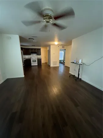 a view of a room with wooden floor