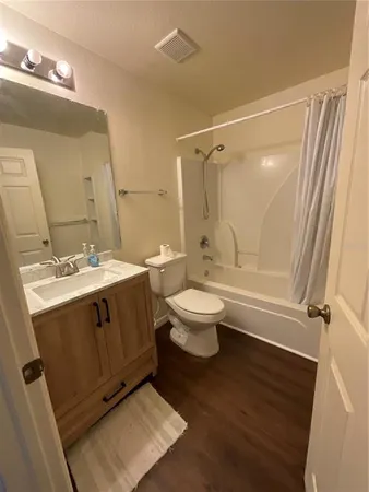 a bathroom with a sink toilet a mirror and shower