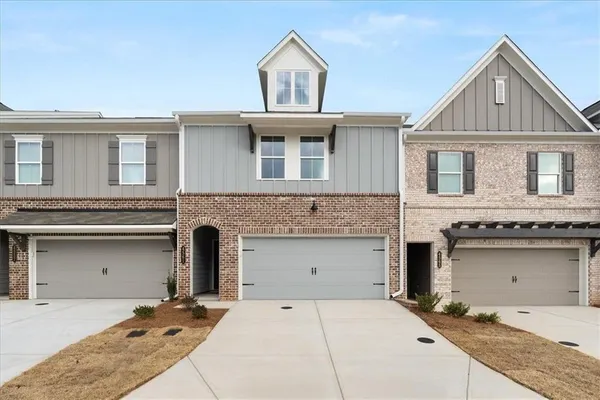 a front view of a house with a garage