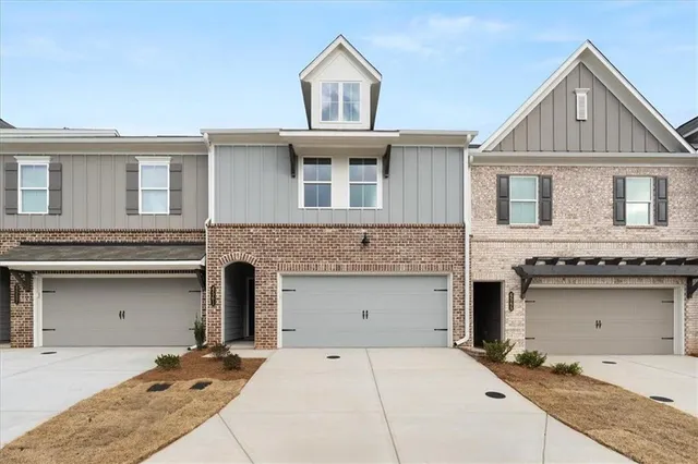 a front view of a house with a garage