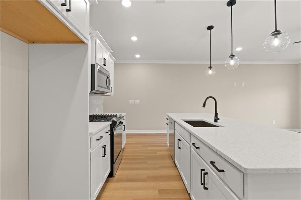 4561 Moray Drive Mableton, GA 30126 - Photo 12 of 34 a kitchen with stainless steel appliances a sink a stove top oven a chimney and a refrigerator