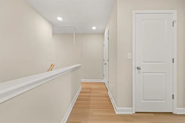 a view of a hallway with wooden floor and a hallway