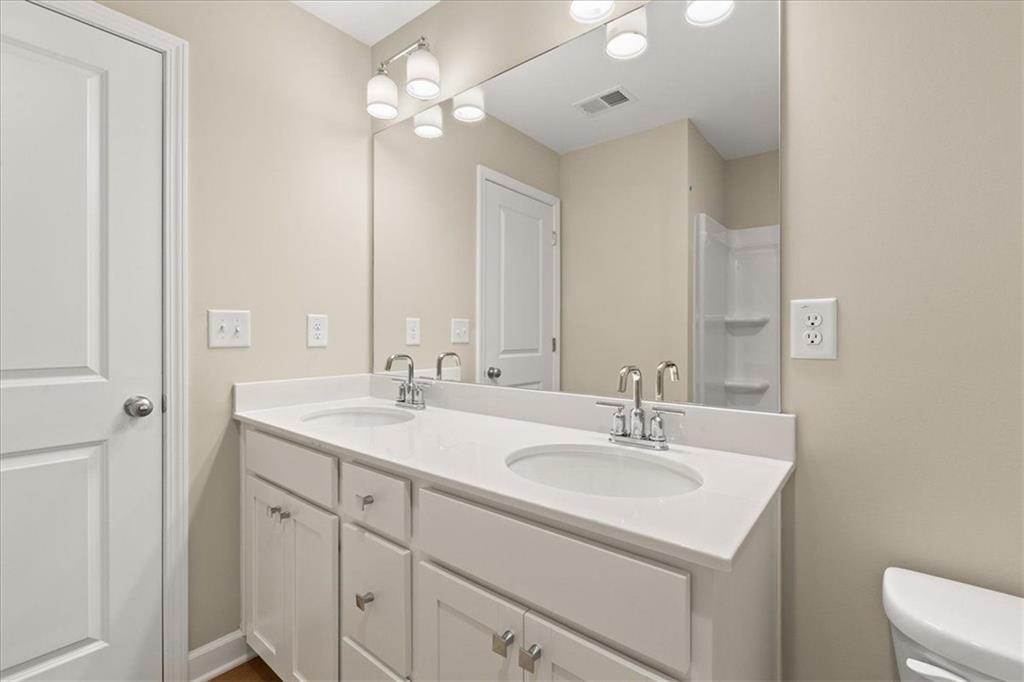 4561 Moray Drive Mableton, GA 30126 - Photo 25 of 34 a bathroom with a sink a light fixture and a mirror