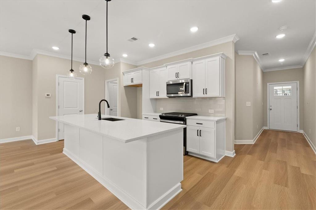 4561 Moray Drive Mableton, GA 30126 - Photo 9 of 34 a large white kitchen with stainless steel appliances