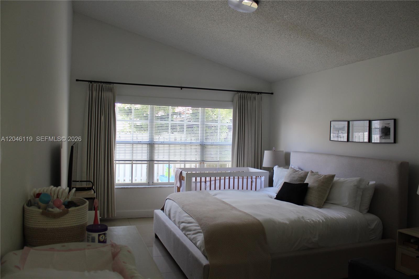 312 Bridgeton Road Weston, FL 33326 - Photo 11 of 13 a bedroom with a bed and glass window