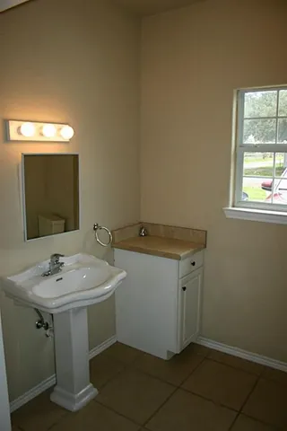 a bathroom with a sink and a mirror