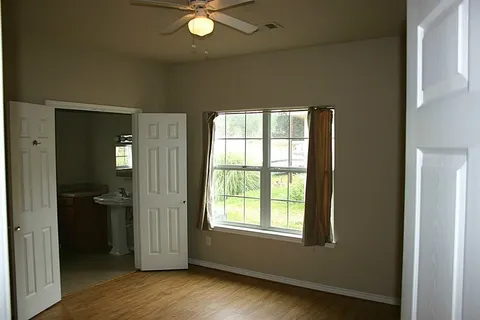 an empty room with wooden floor and a window