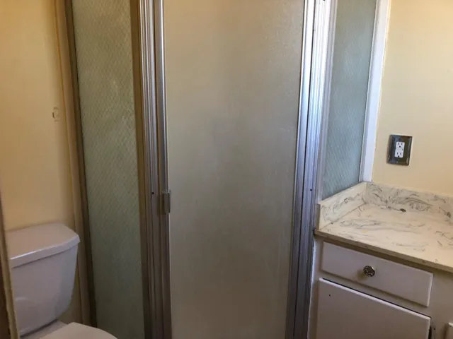 a view of an empty room and wooden floor