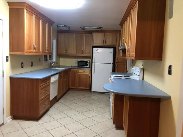 a kitchen with a sink appliances and cabinets