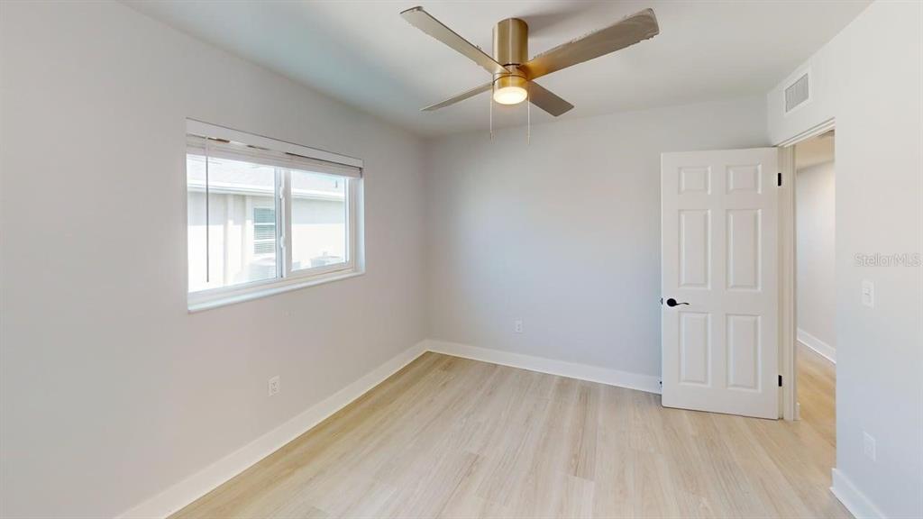 500 129th Avenue East, Unit 1 Madeira Beach, FL 33708 - Photo 15 of 19 an empty room with a window and a fan