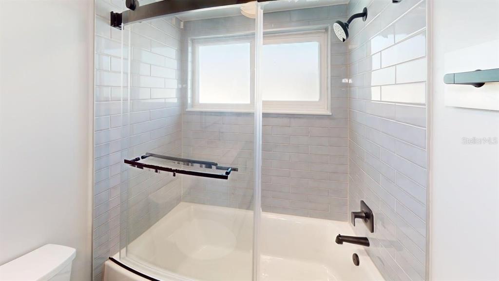 500 129th Avenue East, Unit 1 Madeira Beach, FL 33708 - Photo 16 of 19 a bathroom with a bathtub and shower