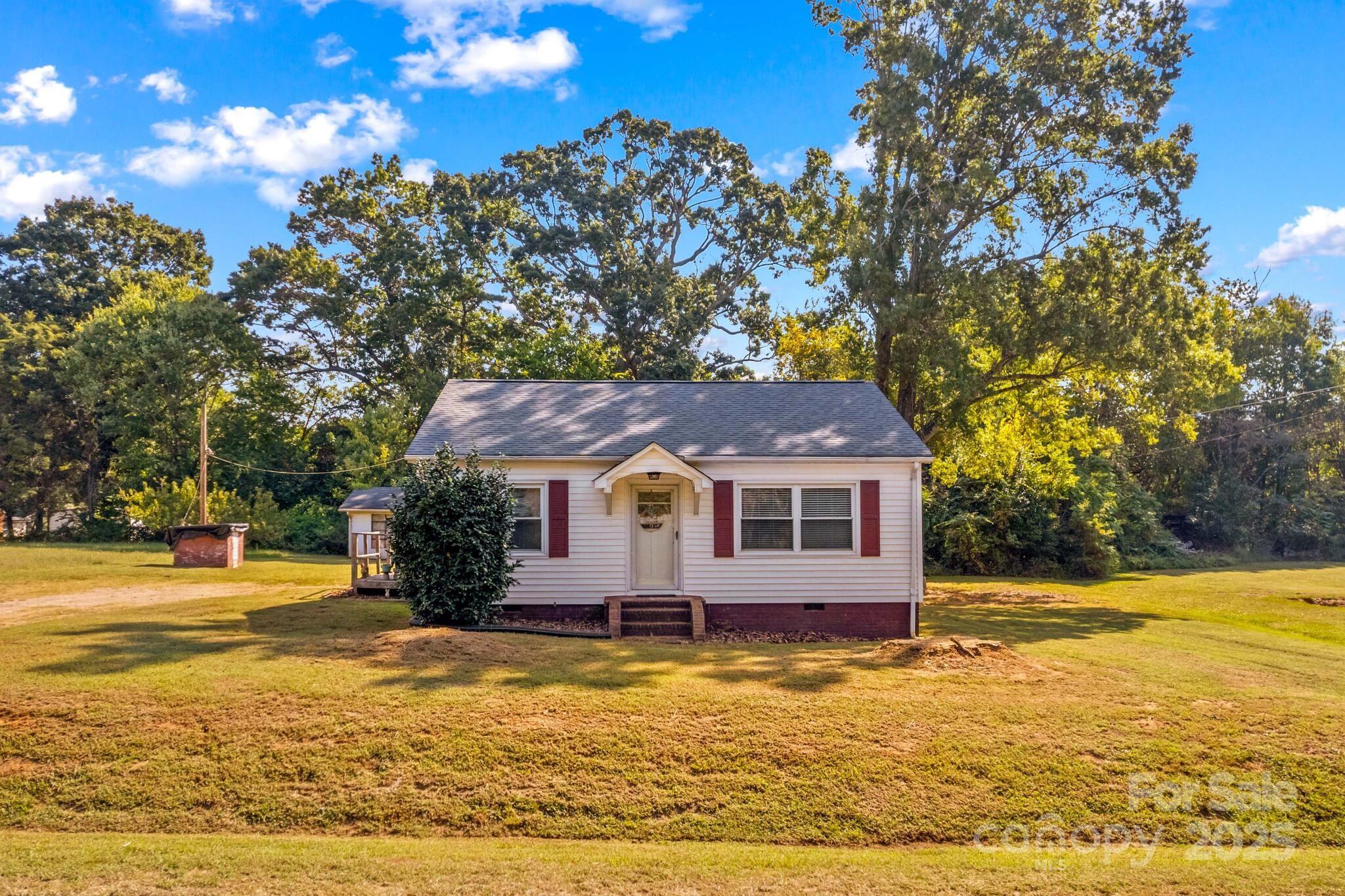 a front view of house with yard and trees
