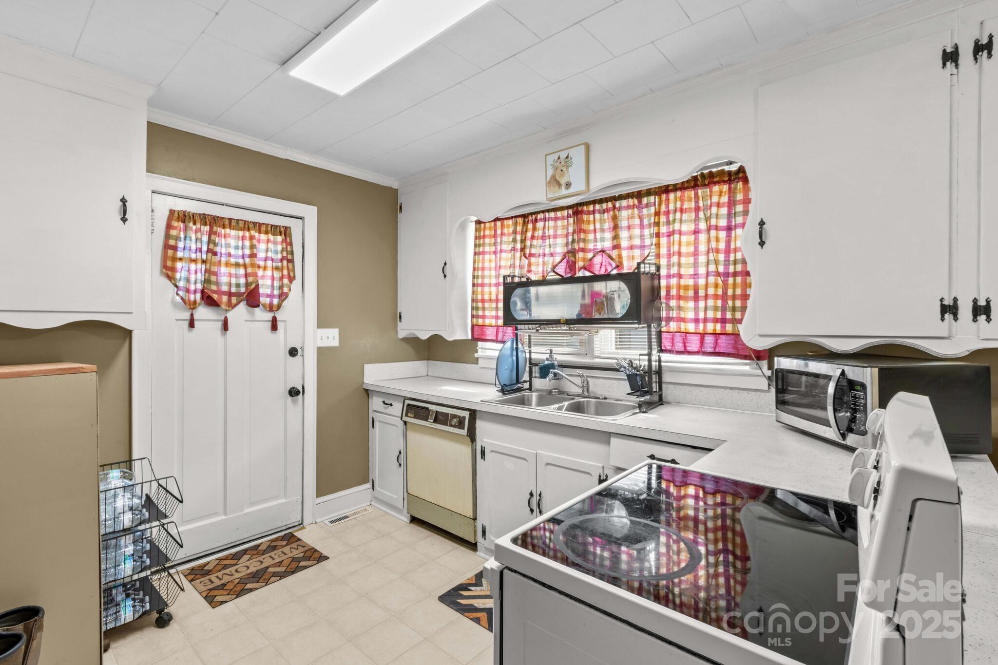 185 Homer Corriher Road China Grove, NC 28023 - Photo 20 of 48 a kitchen with stainless steel appliances granite countertop a stove top oven a sink dishwasher and a refrigerator